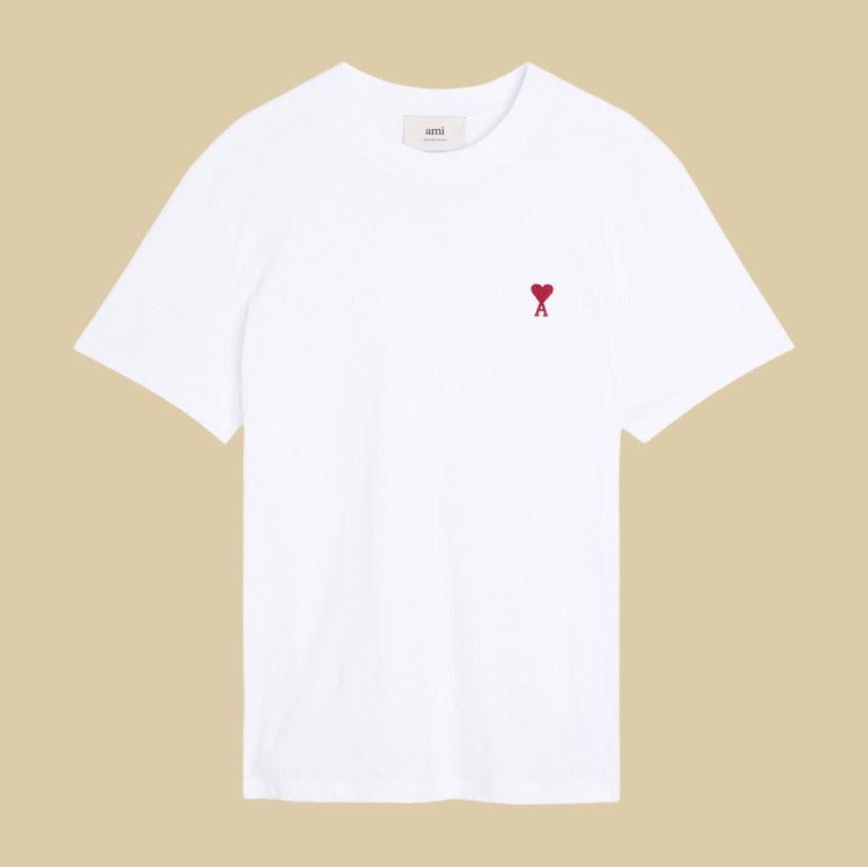 Ami paris White t-shirt with a red heart logo on a beige background