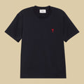 Ami Paris Black t-shirt with a red heart logo on a beige background