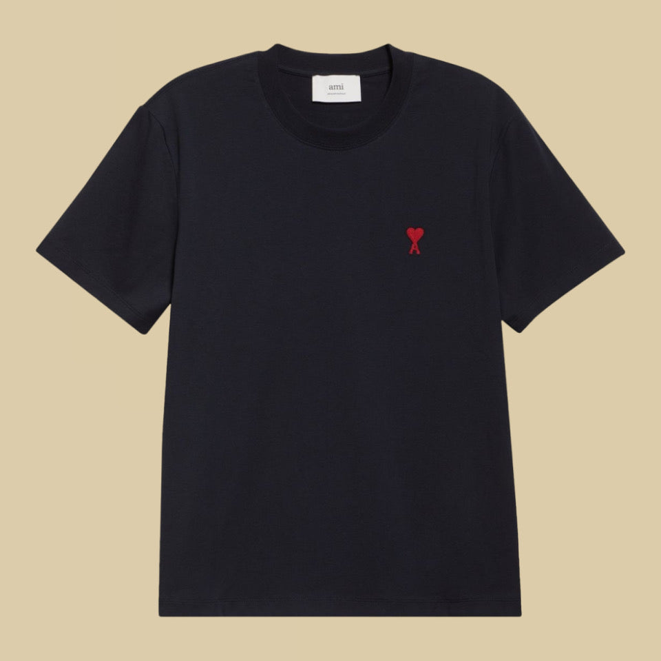 Ami Paris Black t-shirt with a red heart logo on a beige background