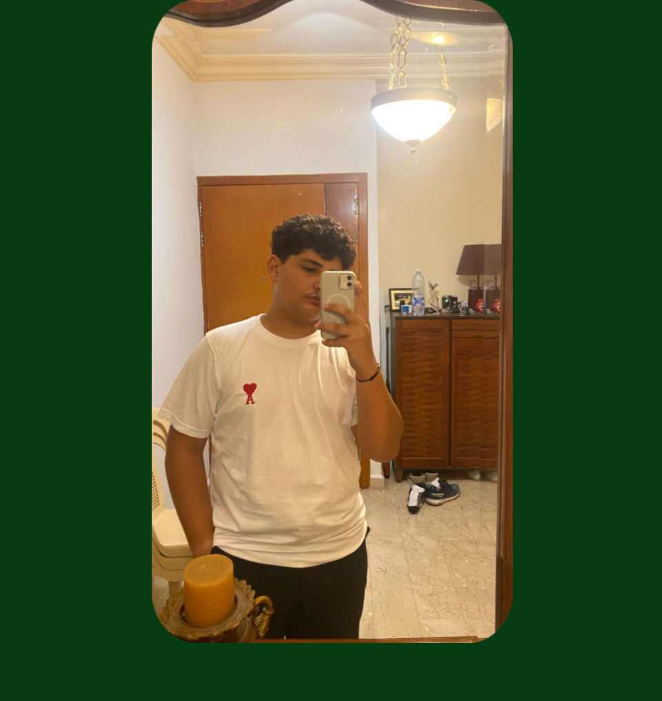 Customer taking a mirror pic wearing a white Ami Paris T shirt For a review 