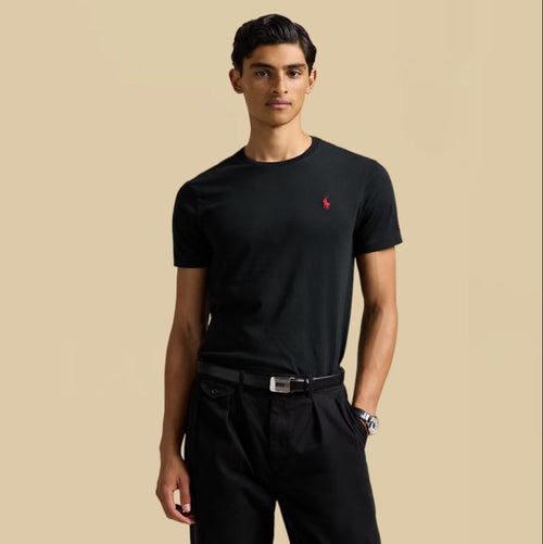 Man wearing Ralph Lauren black t-shirt with a red logo on a beige background